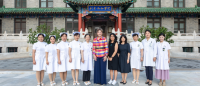 Group of nursing students with Dean Frazier standing in front of building in China.